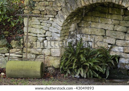 Old Stone Garden Roller and Cotswold stone arch
