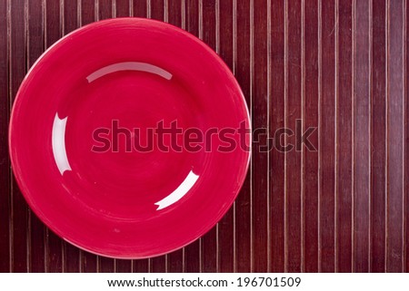 Ceramic dish on wooden kitchen litter. Cookware.