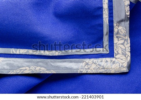 Blue fabric trimmed along the edge of ornament.