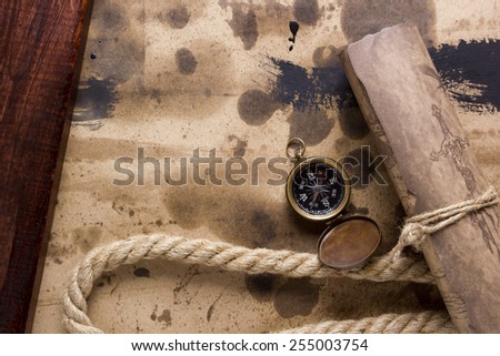 Compass and marine rope with a rolled scroll.