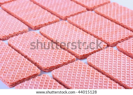 Pink sweet wafers are laid out by equal numbers.
