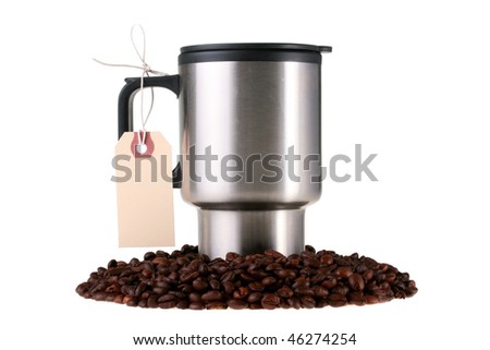 Mug for coffee among coffee grains with the label adhered to the handle.