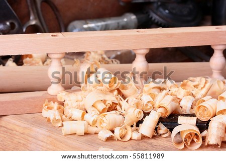 Wood shaving in a workshop of the carpenter on a metalwork workbench.