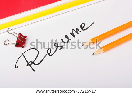 On a white background an inscription - Resume with two thick writing-books and pencils.