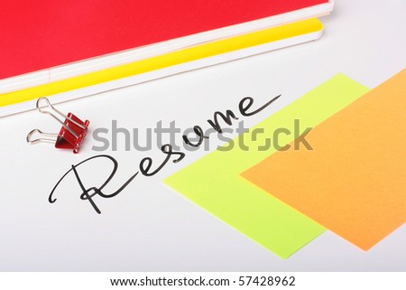 On a white background an inscription - Resume with two thick writing-books and paper for messages.
