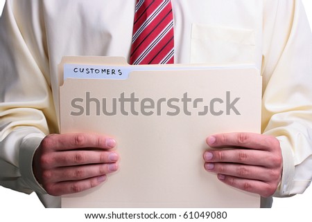 Man in a shirt and a tie holding a manila customer folder.
