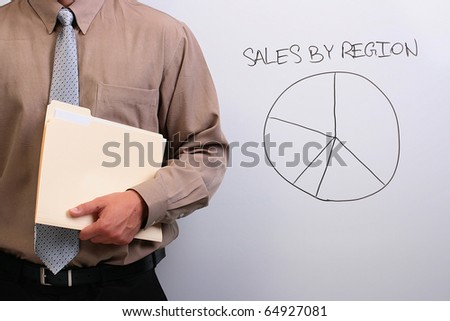 Man in a shirt and a tie holding a manila folder next to a drawing of a pie chart.