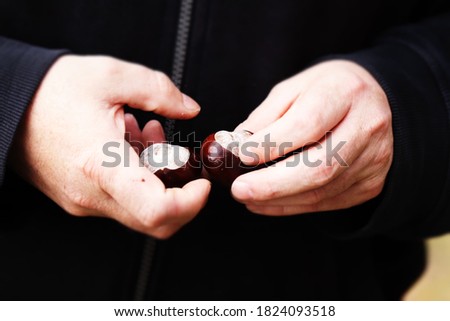 Image, Stock Photo Hand holding immature chestnut in front of green lawn. Protection. Nature. Appreciation