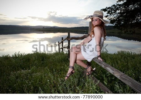 redhead woman in a fence in the afternoon/redhead woman