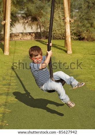 Kid doing summer fun sport on rope slide