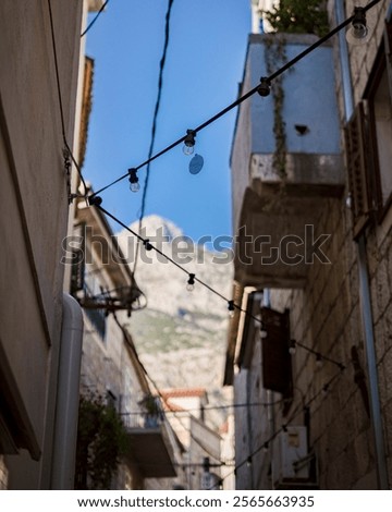 Similar – Image, Stock Photo Lights hang overhead on a clear summer evening