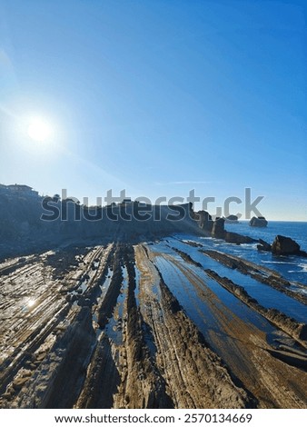 Similar – Foto Bild warm angestrahlter Felsen vor blauem Himmel