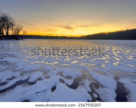 Similar – Image, Stock Photo Sunset over a frozen lake. Sunbeams falling on water. Shadows of trees on the ice covering the lake. Aerial view of a frozen lake. Ice sheet background. Frozen grass in water