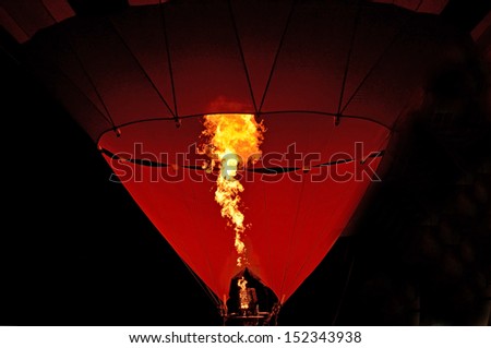 Close up of hot air balloon burner flame glowing at night