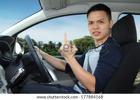 An angry driver showing the middle finger