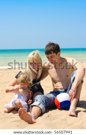 young family on the beach,focus is mainyly on the mothers face