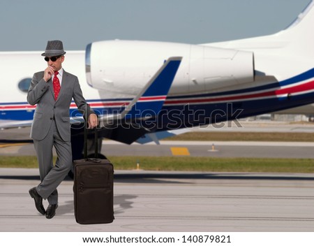 Business man standing next to a private jet