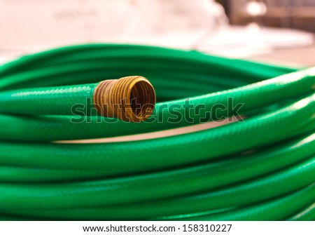Green coiled rubber hose