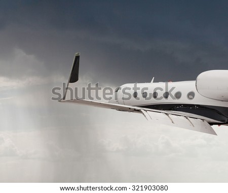 Close side view of a private jet flying
