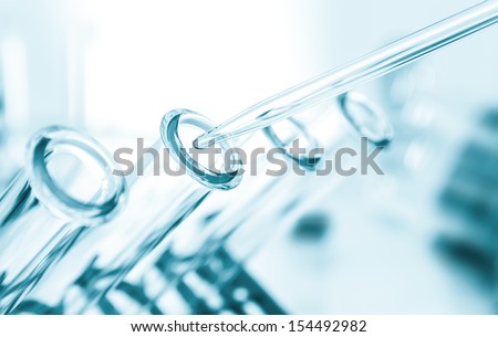 pipette and test tube on blue background