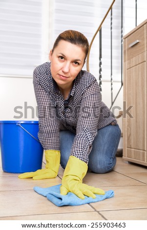 Young woman washing furniture at home.