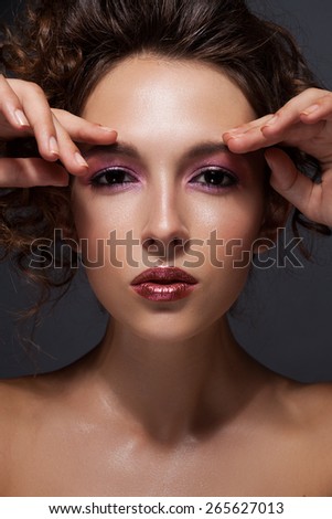 Beautiful woman  framing her face with hands and smiling