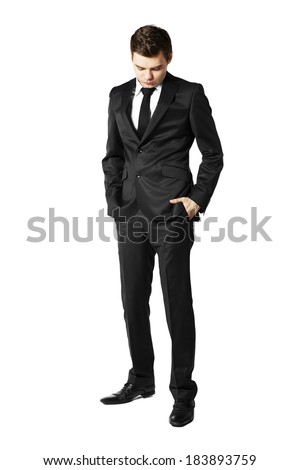 Young businessman looking down. Man against white background