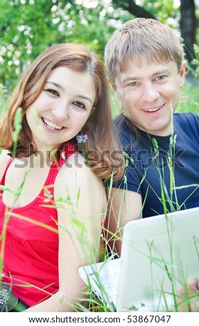 Young pair, on nature with a notebook