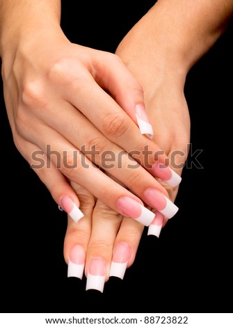 Beautiful hands with french manicure on black background