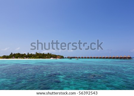 Water Villas and fishing boats in the Ocean. Welcome to the Paradise! Maldives. High Contrast.