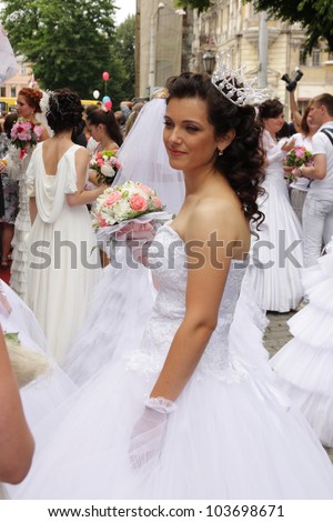 ODESSA, UKRAINE - MAY 27: Annual event Bride Parade. Happy excited participants in fiancee\'s gowns take part in celebration of marriage and romance Bride Parade on May 27, 2012 in Odessa, Ukraine
