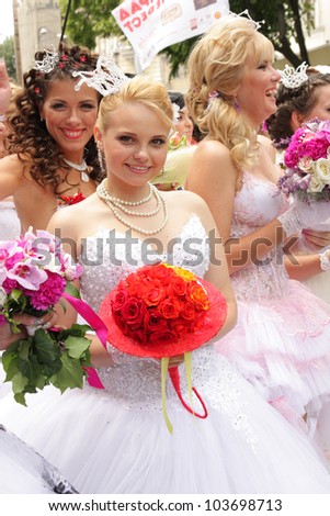 ODESSA, UKRAINE - MAY 27 : Annual event Bride Parade. Happy excited participants in fiancee`s gowns take part in celebration of marriage and romance Bride Parade on May 27, 2012 in Odessa, Ukraine