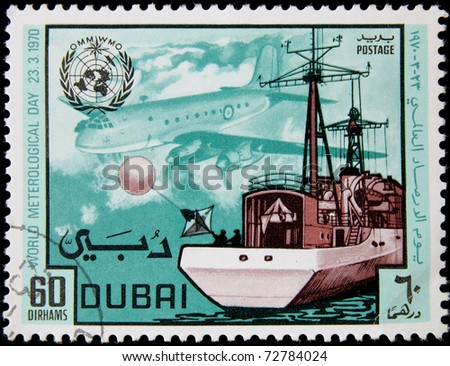 DUBAI - CIRCA 1970 : A post stamp printed in Dubai show ship and plane, devoted world meteorological day, circa 1970