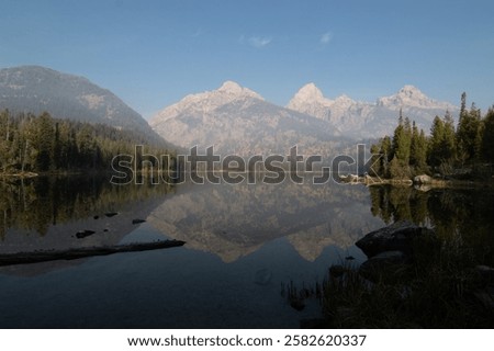 Similar – Foto Bild Ruhiger See, umgeben von Bergen mit Herbstbäumen bei Sonnenuntergang