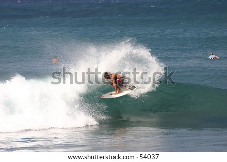 Pro surfer at North Shore throwing spray