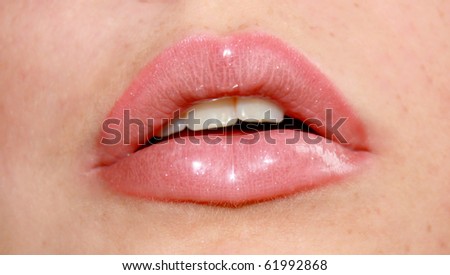 close up of a pink mouth with lipstick and lip gloss