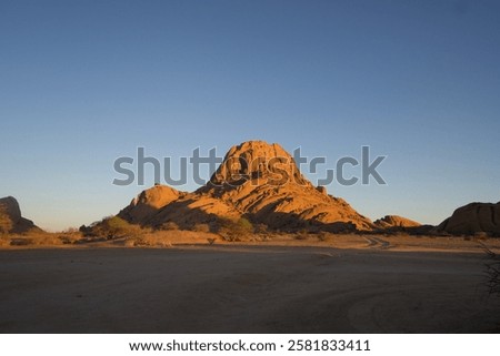 Similar – Image, Stock Photo Beautiful sunrise at Damaraland, Namibia. Group of people seen from their back walking up a mountain.