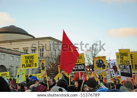 COPENHAGEN - DECEMBER 12: Crowd of aggressive protestants with banners and flags during environment protest, in state central market, December 12, 2009 in Copenhagen, Denmark.