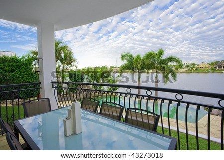 Balcony entertainment area of waterfront house