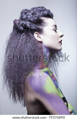 young woman in studio with body paint and hair done for hair competition