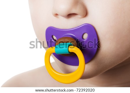 Little child boy and plastic baby soother pacifier