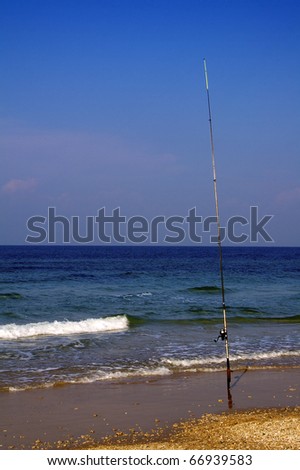 Fishing rod standing at the beach