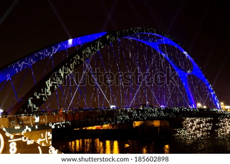 FRANKFURT, GERMANY - APRIL 01, 2014: Illuminated Osthafenbruecke at night on April 01, 2014 during the Luminale 2014. The Luminale takes place in Frankfurt every 2 years.