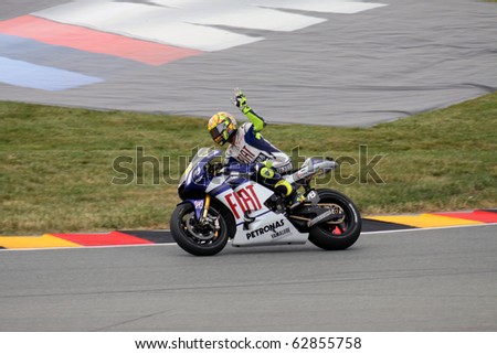 SACHSENRING, GERMANY - JULY 17: Italian rider Valentino Rossi greets his fans during practice at Eni German Motorcycle Grand Prix on July 17, 2010 in Sachsenring, Germany