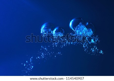 Clean blue water splash on dark blue background