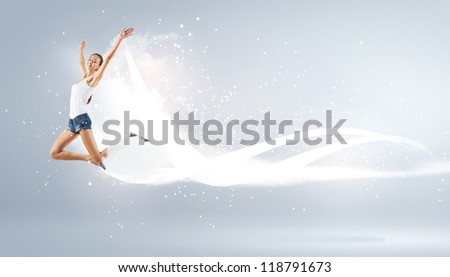 Modern style female dancer jumping and posing with lighting