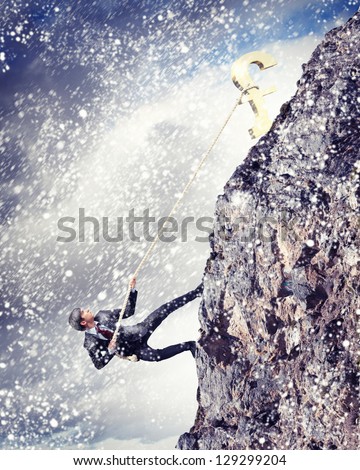 businessman climbing hill with pound on top