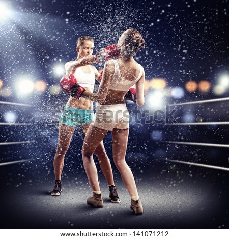 Two young pretty women boxing in ring