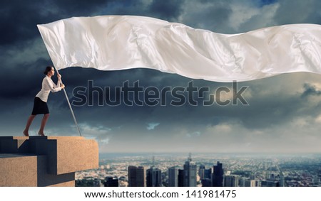 Image of attractive businesswoman holding white flag. Place for text