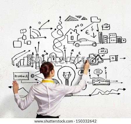 Businesswoman standing with back drawing business ideas on wall